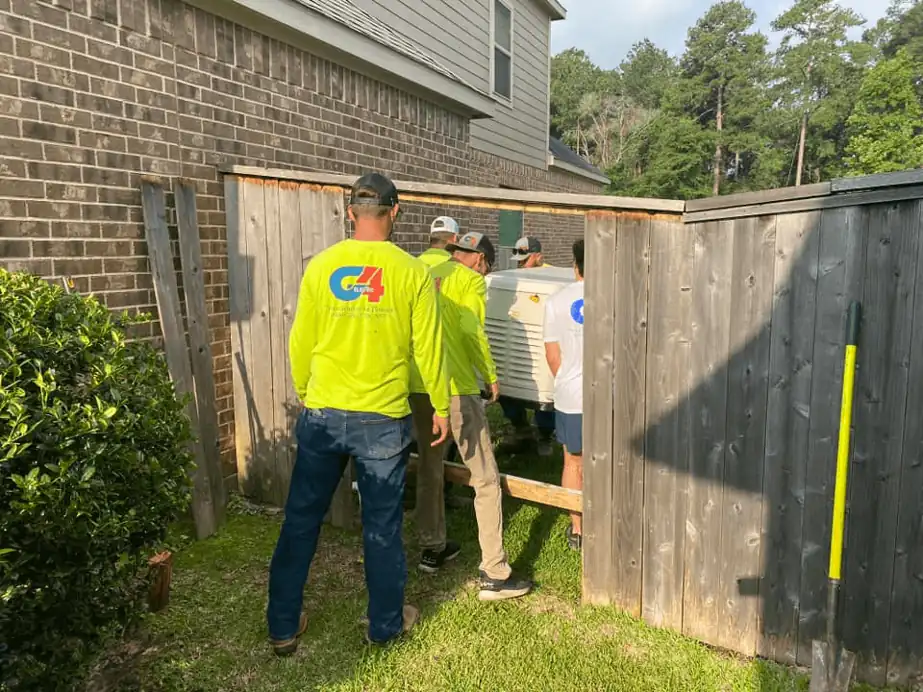 G4 Electric crew in lime shirts setting a standby generator behind a wood fence